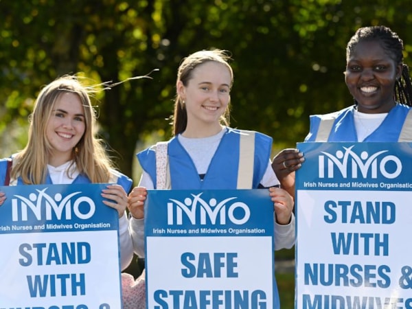 nurses holding safe staffing signs